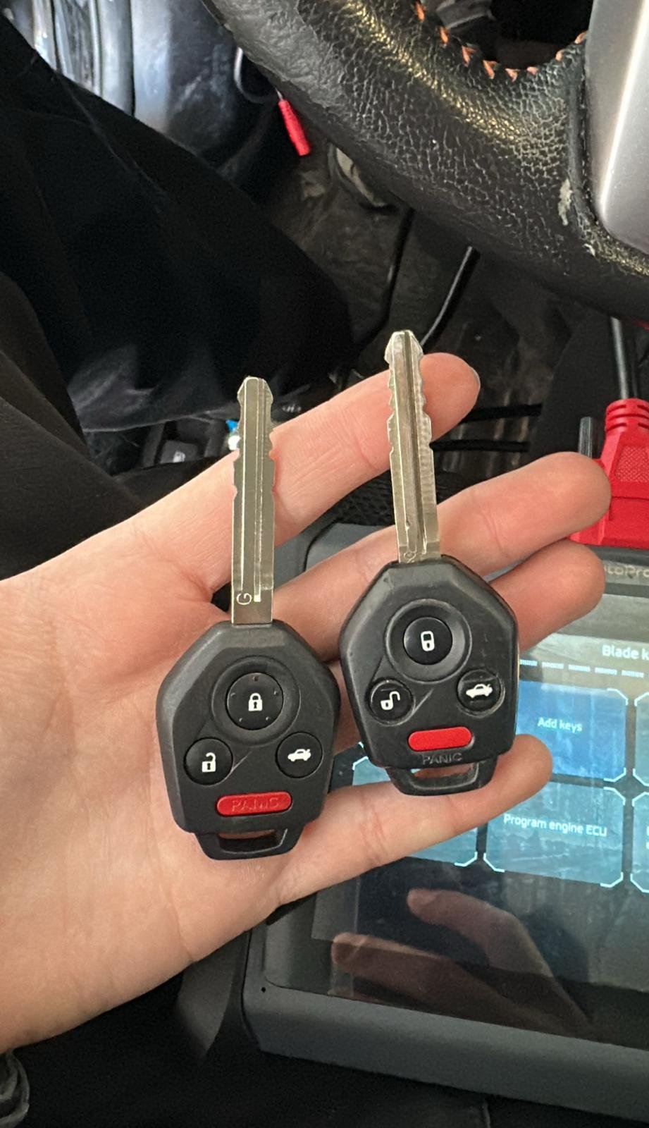 Two vehicle keys held inside a car
